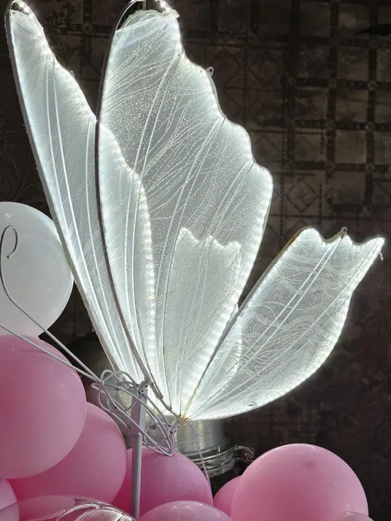 Illuminated fabric butterfly light among pink balloons