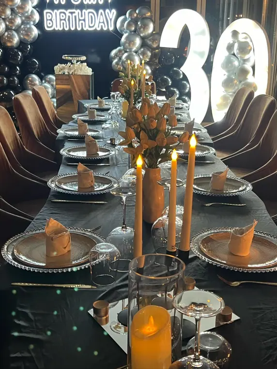 Dressed banquet table with tulips and candles before lit number 30