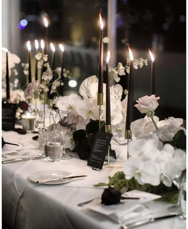 Candlelit banquet table with white orchids and tapered candles