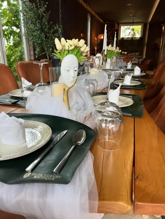 Long dressed table with tulle runner, tulips, candles and placemats