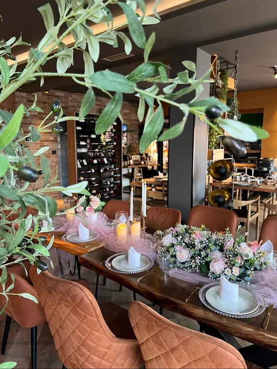 Table with pink tulle runner, rose arrangement and candles