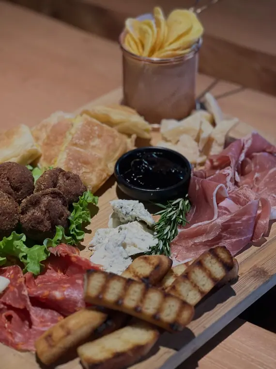 Charcuterie board with meatballs, cheese and grilled bread
