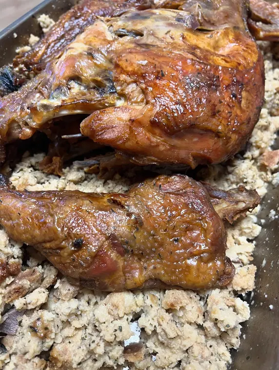 Close-up of glazed roast poultry on bulgur