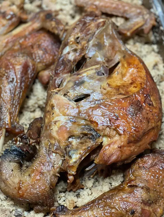 Close-up of roast poultry pieces on bulgur