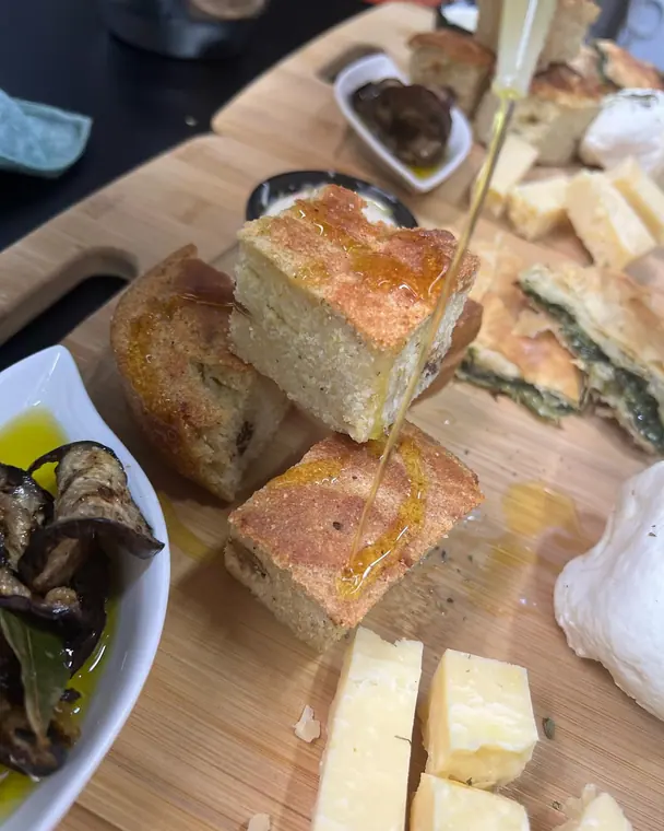 Honey drizzled onto cornbread squares on a wooden board