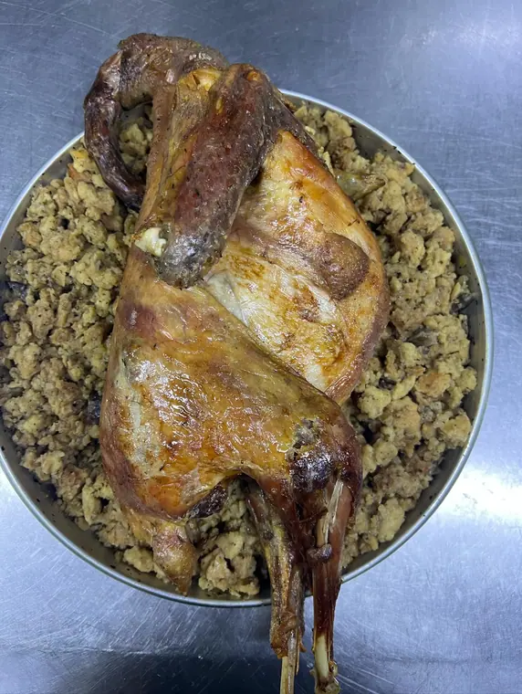 Overhead view of whole roasted fowl on bread stuffing
