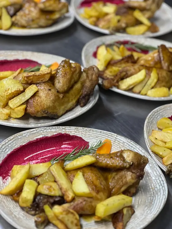 Plated half chicken with potato wedges and beetroot puree