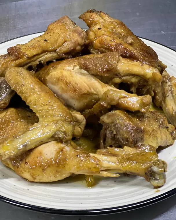 Roasted chicken pieces plated on white dish