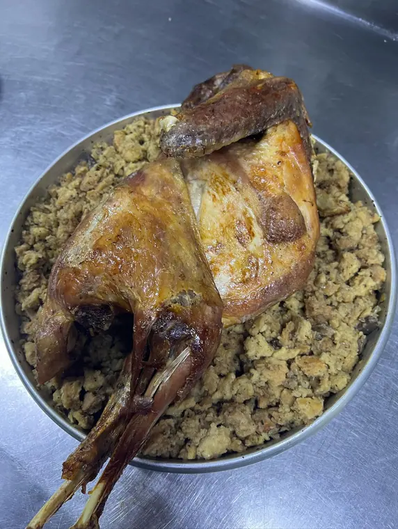 Whole roasted fowl on bread stuffing, viewed from above