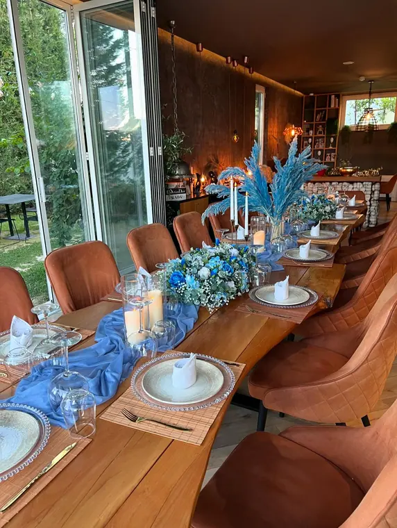Banquet table with blue chiffon runner and rose centrepieces