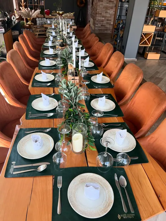 Banquet table with green placemats and candle centrepiece