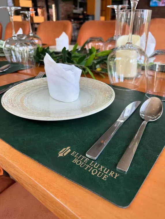 Close view of place setting with plate, napkin and placemat