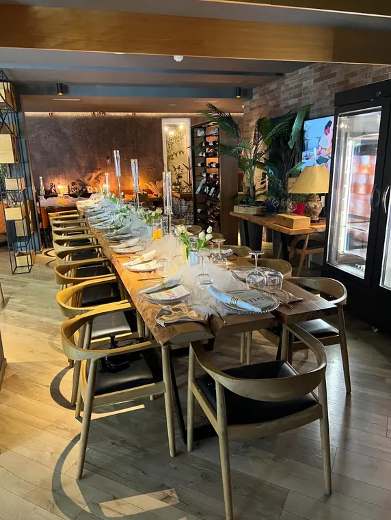 Long set dining table with candles, wine rack and meat cabinet