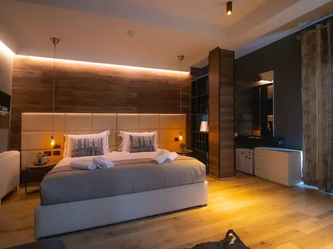 Bedroom with wood-panelled headboard wall and pendant lights
